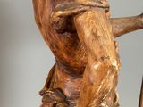 statue of a man with a staff and a hat on his head