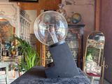 a glass ball sitting on top of a black table