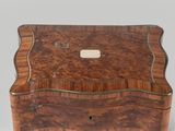 an old wooden box with a metal handle and a wooden lid