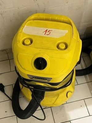 a yellow blow dryer sitting on the floor in a bathroom