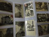 a person holding a bunch of old postcards in their hand