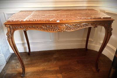 a table with a marble top in a room
