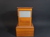 a small wooden clock with a glass display on top