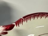 a white bowl with a red design on it