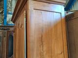 a large wooden cabinet with a tv on top of it