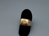 an image of a gold ring on a black velvet ring holder