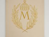 a close up of a book with a crown on top of it