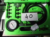 a green box with a gauge and a hose in it