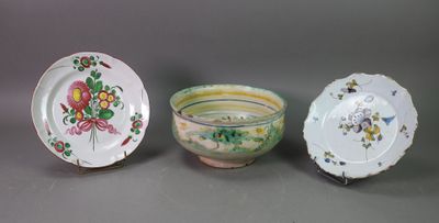 three plates and a bowl are sitting on a table