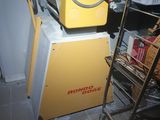a yellow machine that is sitting on top of a cart