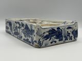 a blue and white vase with a bird design on it