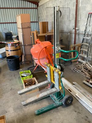 a man standing next to a stack of pallets in a warehouse