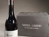 a bottle of wine sitting next to a box of wine