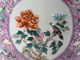 a colorful vase with a bird and flowers on it