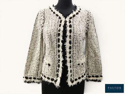 a close up of a black and white jacket on a mannequin mannequin