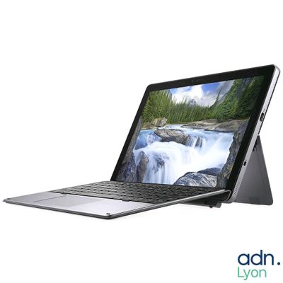 a laptop with a picture of a waterfall on the screen