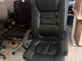 une chaise de bureau noire au milieu d'une pièce
