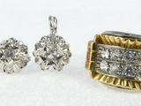 a close up of two rings and a pair of earrings