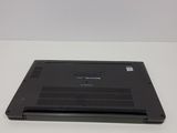 a black laptop sitting on a white surface