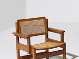 the chair is made of wood and has a rattan seat