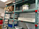 a shelf with baskets and baskets on it in a kitchen