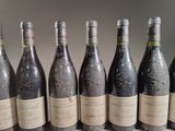 six bottles of wine are lined up in a row on a table