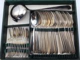silverware in a green box with spoons and spoons in it