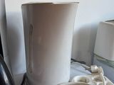 a picture of a coffee maker and a cup on a table