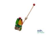 a small toy that is sitting on top of a wooden stick
