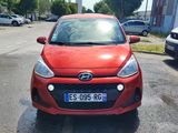 une voiture rouge garée sur le bord de la route