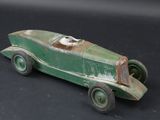 a green toy car that is sitting on a black surface
