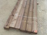 a pile of wood sitting on the ground in the middle of the road