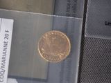 a gold coin sitting on top of a piece of paper
