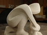 a white sculpture on a wooden table in a room