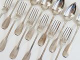 a lot of silver spoons and forks on the table
