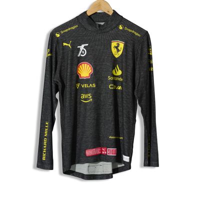a black long - sleeved shirt with yellow and red logos on it