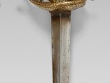 an image of a sword with a gold handle on a white background