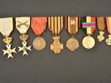 several medals are arranged in a row on a black surface