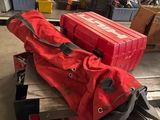 two red suitcases sitting on top of a wooden table