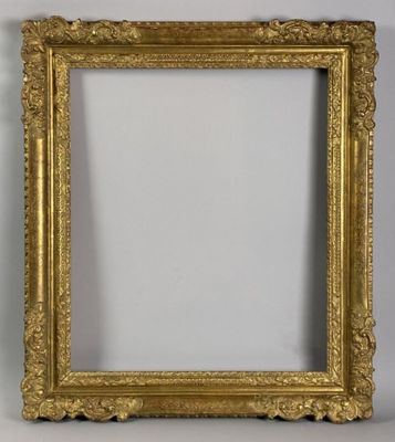a gold picture frame with a white wall behind it