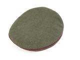 green beret with red pips on top of it on a white surface