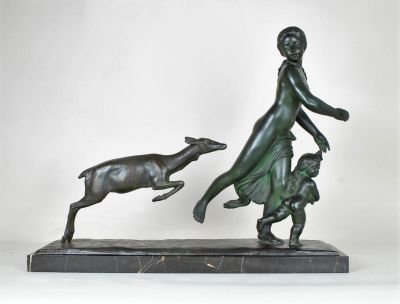 bronze statue of a woman and a dog on a marble base