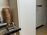 a white refrigerator in a kitchen with a black counter top