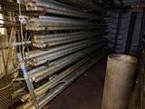 a lot of pipes that are stacked up in a room