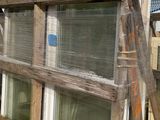 many windows that are stacked up on a pallet