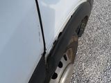 a white truck with a flat tire on the road