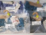 four bags of clothes that are wrapped in plastic