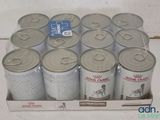 several cans of canned food are in a cardboard box on a table