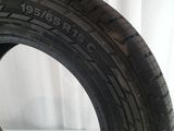 a close up of a tire on a white surface with a curtain in the background