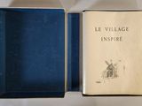 a book in a blue box on a white surface